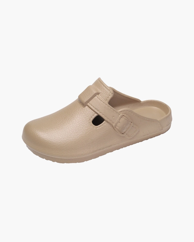 Single beige buckle clog with strap and textured sole, side view