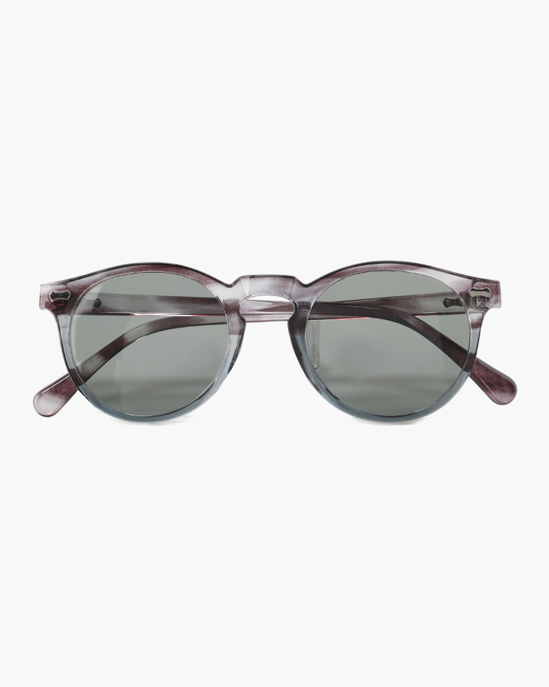 Round sunglasses with translucent grey frame and green-grey tinted lenses, front view
