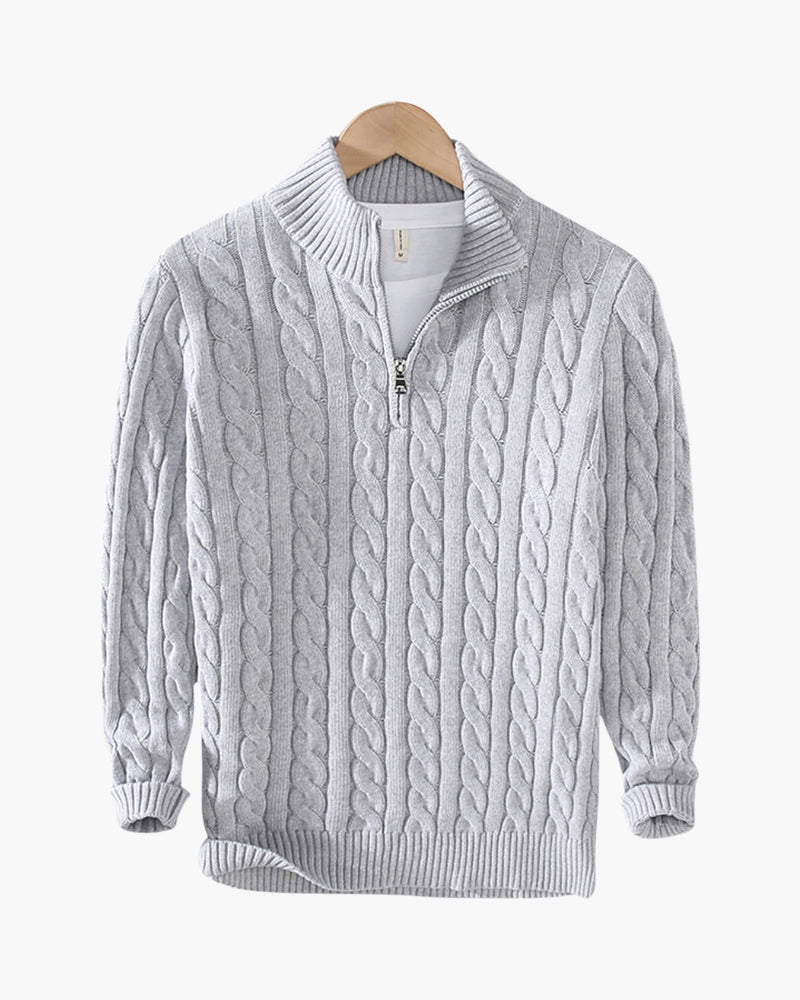 Grey cable-knit half-zip jumper with ribbed cuffs on a wooden hanger, flat front view