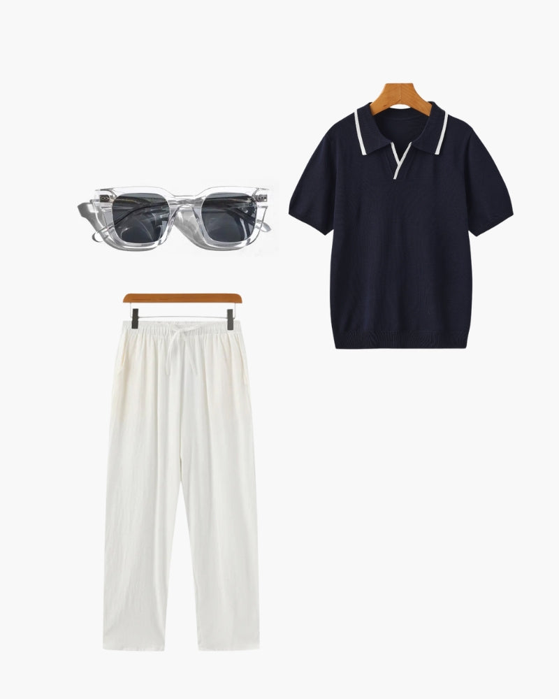 Flat-lay outfit set: navy knit polo with white tipping, white drawstring trousers and clear-frame sunglasses
