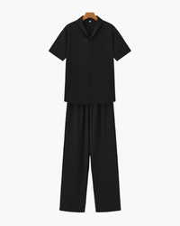 Black short-sleeve polo and wide-leg drawstring trousers set, flat front view on a hanger