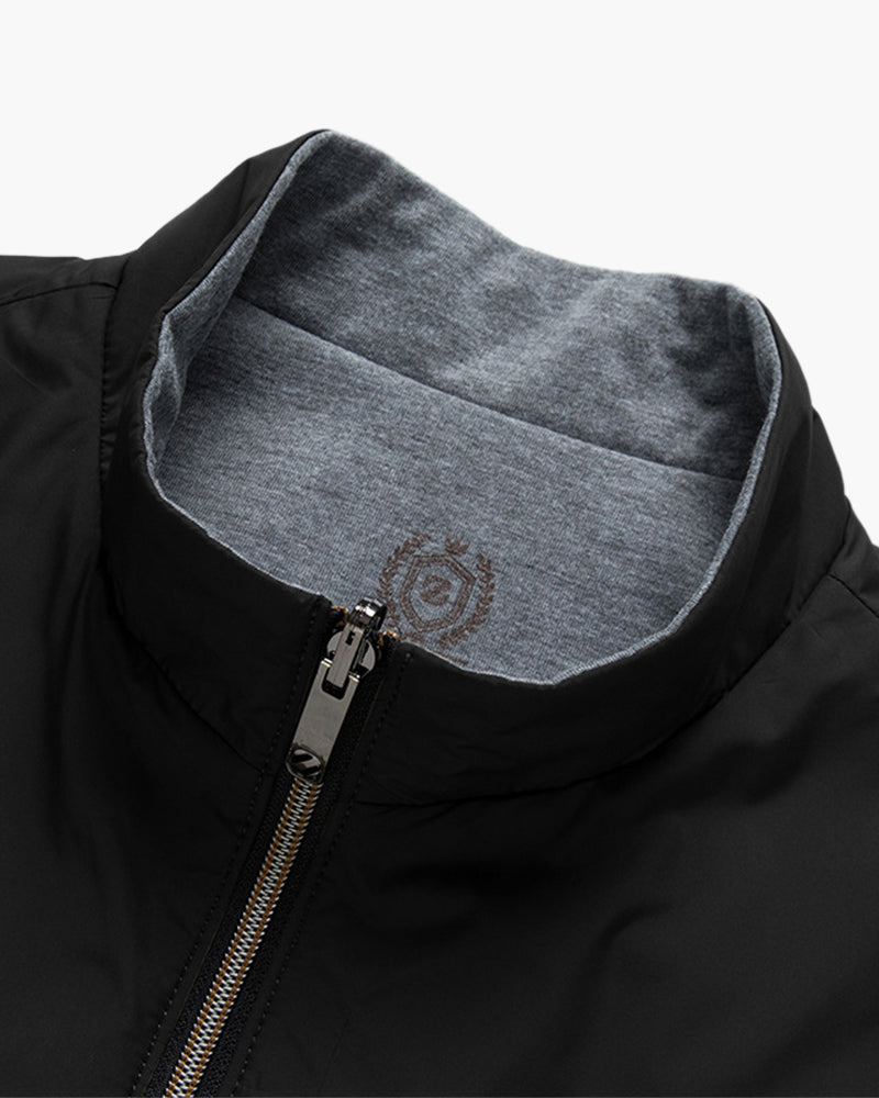 Close-up of black bodywarmer stand collar with gunmetal zip and grey lining