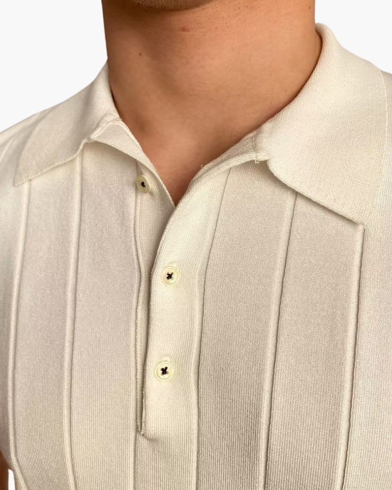 Close-up of a cream ribbed knit polo collar and two-button placket