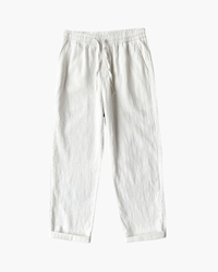 White linen drawstring trousers with elastic waist and rolled hems, flat-lay front view