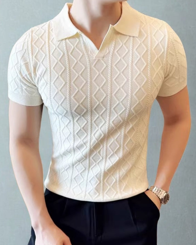 Cream diamond-textured knit polo with open V collar, worn with navy trousers and a watch