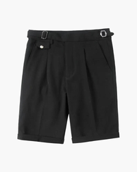 Black pleated shorts with side-adjuster buckles, button tab pocket and turn-up hems, flat-lay front view