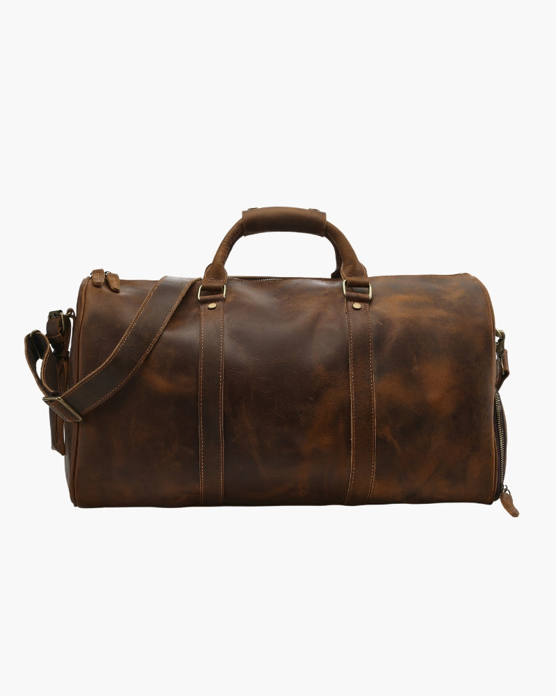 Brown distressed leather duffle bag with top handle, shoulder strap and brass hardware, front view