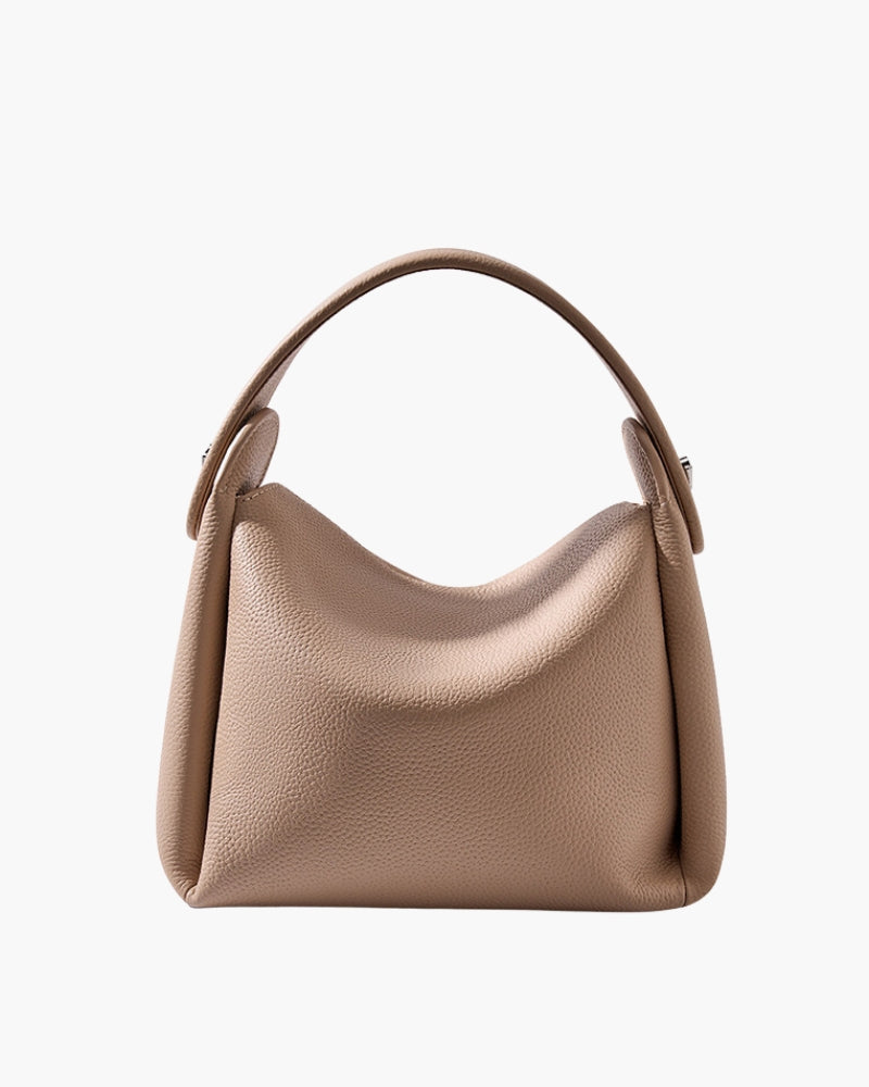 Beige grained-leather top-handle handbag with soft slouchy body, front view