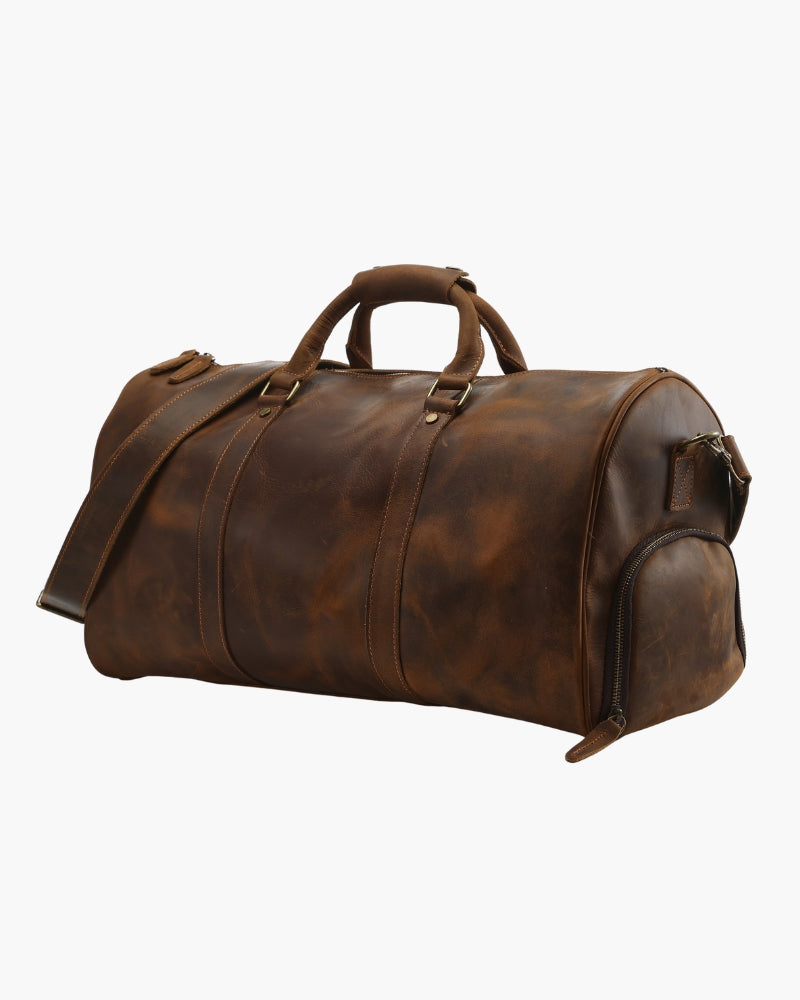 Distressed brown leather duffle bag with end zip pocket, shoulder strap and top handles, angled view