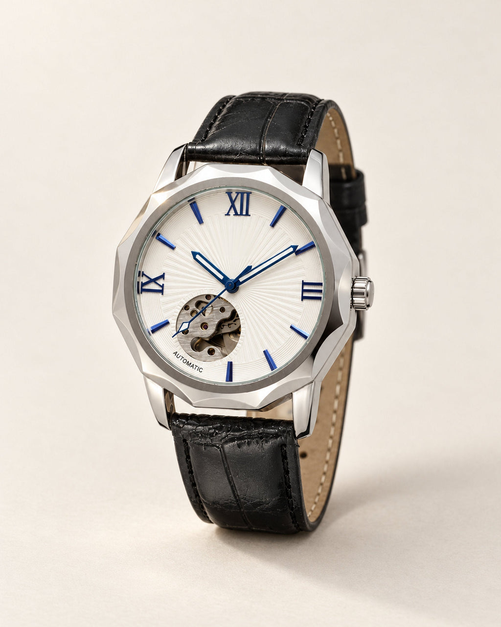 Skeleton dial watch with white face and blue hands on a black croc-embossed strap, angled studio view