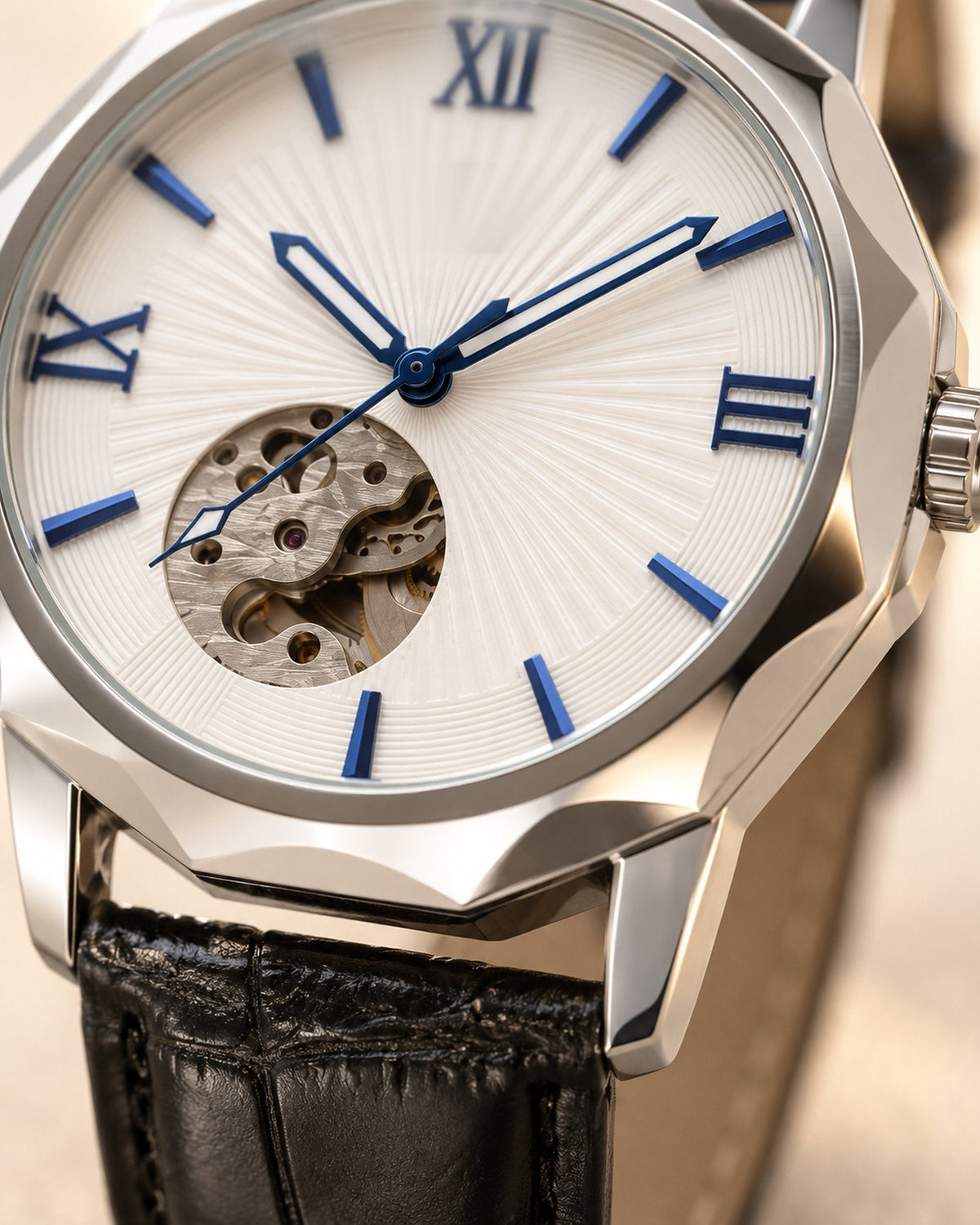 Close-up of a white skeleton dial with blue Roman numerals, exposed movement and faceted steel case