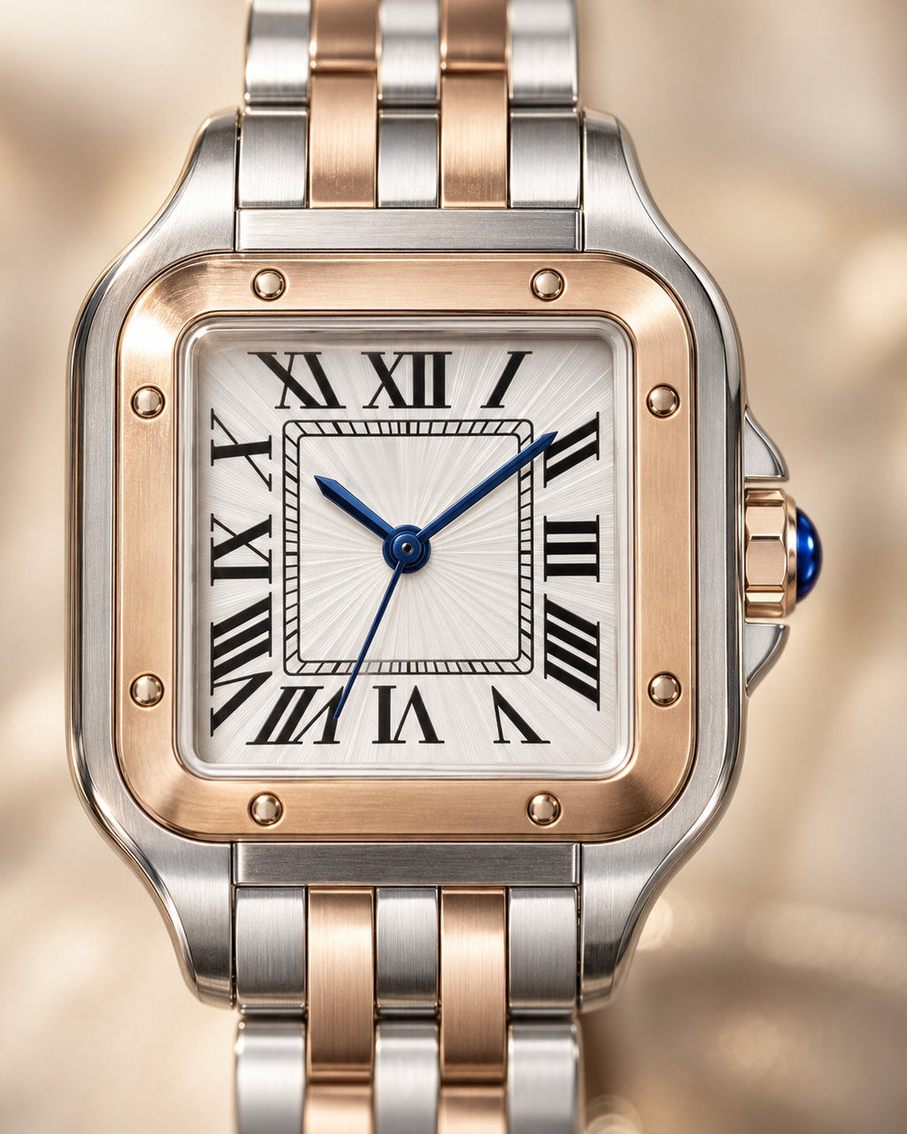 Close-up of white Roman-numeral dial with blue hands, rose-gold bezel screws and blue crown stone