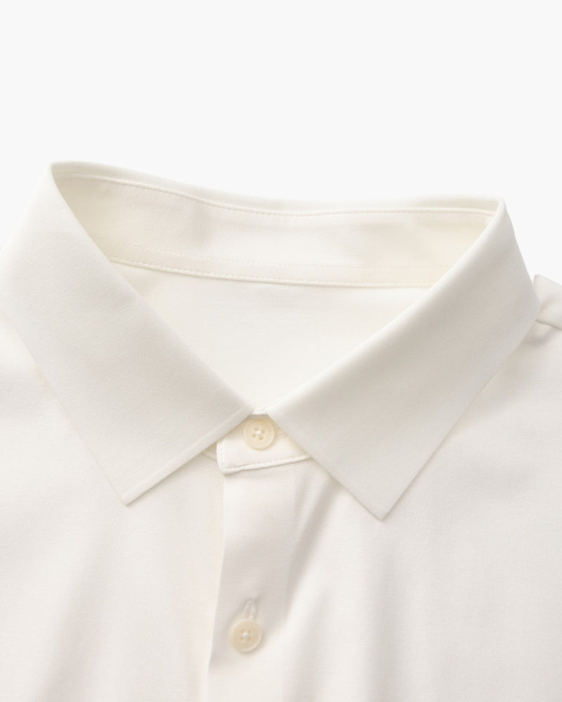 Close-up of white shirt collar and cream buttons, men's stretch cotton shirt