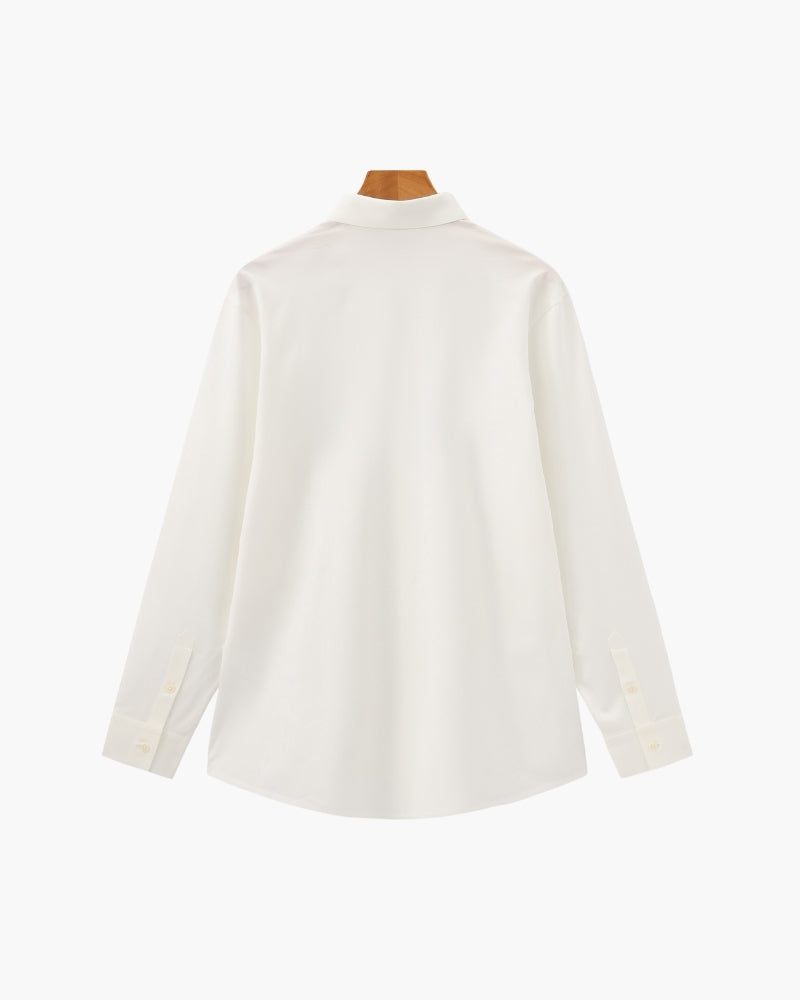 White long-sleeve shirt on a wooden hanger, flat back view with curved hem