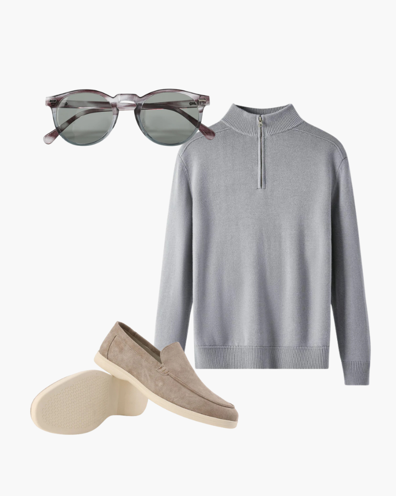 Jersey gris con cuello de cremallera, gafas de sol redondas tintadas en verde y mocasines de ante topo, conjunto de outfit en plano