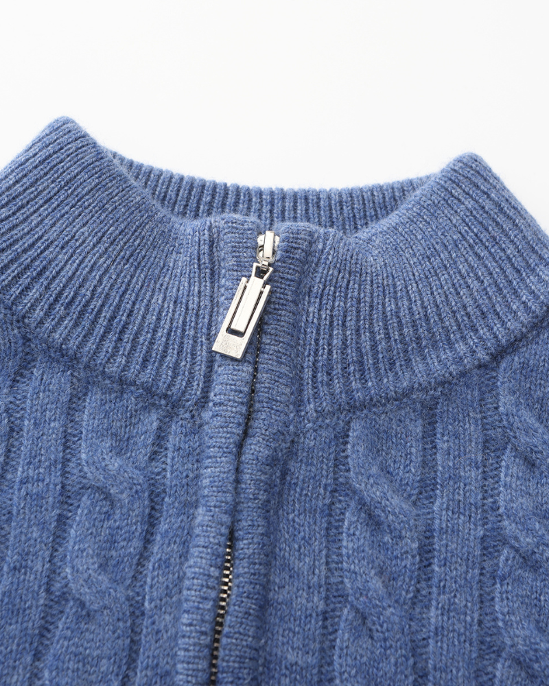 Close-up of blue cable-knit funnel collar with silver-tone zip puller