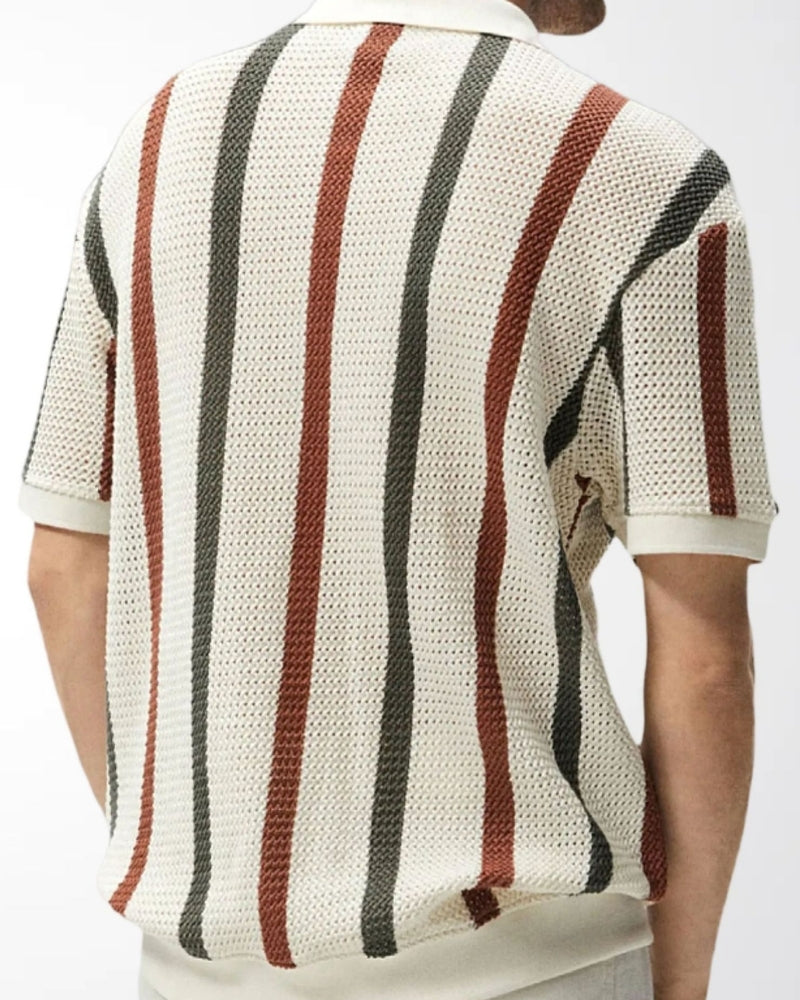 Back view of man in cream open-knit polo with dark green and rust vertical stripes