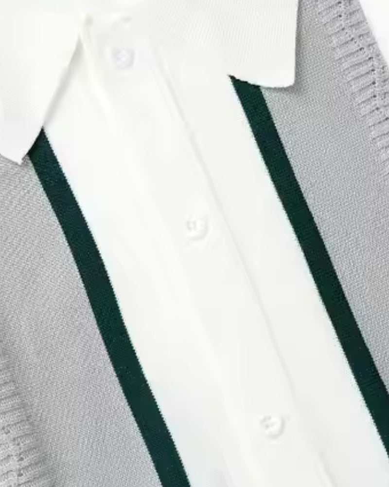 Close-up of a white knit polo placket with grey panel, dark green stripe and buttons