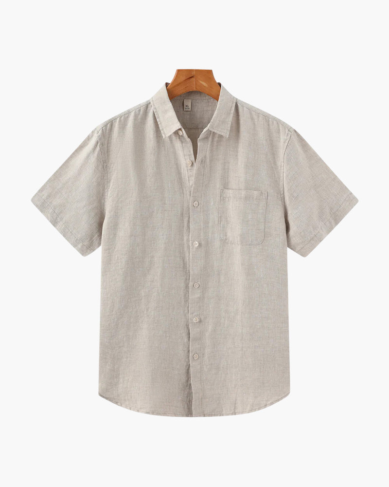 Beige short-sleeve linen shirt with chest pocket on a hanger, front view