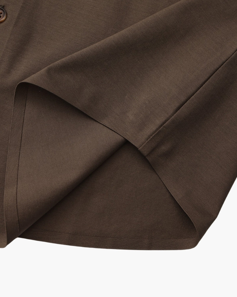Close-up of dark brown shirt hem and side seam, men's stretch cotton shirt