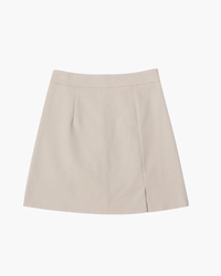 Beige high-waisted A-line mini skirt with front slit and darts, flat-lay front view