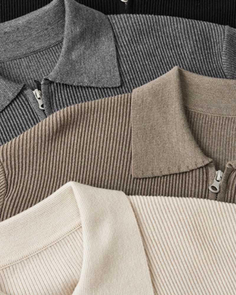 Overhead detail of full-zip wool jumper collars in grey, taupe and cream with zip pulls