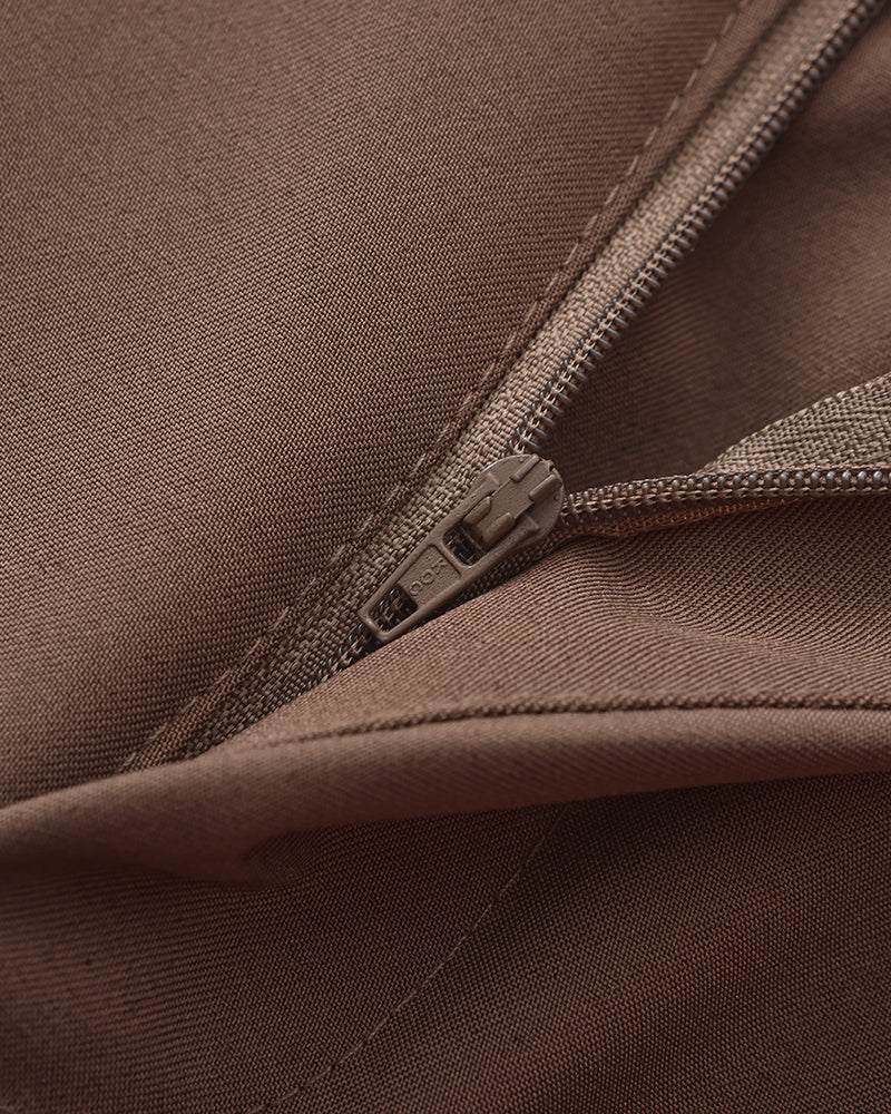 Close-up of brown trousers zip fly and fine twill fabric, flat-lay detail shot