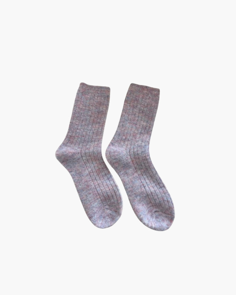 Pair of lilac-pink ribbed cashmere socks with a speckled melange, flat on white