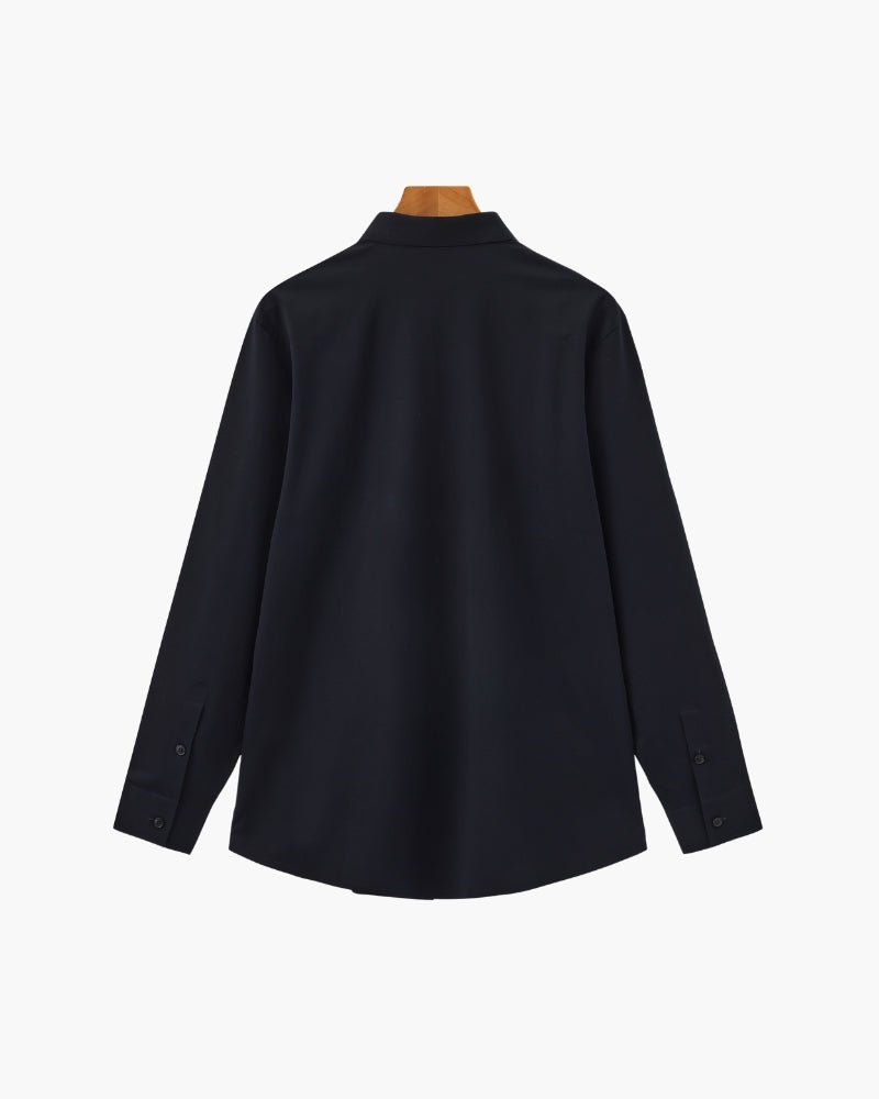 Navy long-sleeve shirt on a wooden hanger, flat back view with curved hem