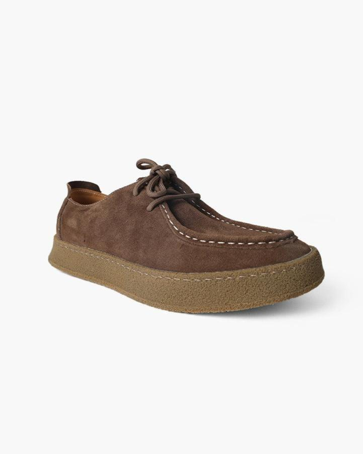 Dark brown suede moc-toe lace-up shoe with white stitching and gum crepe sole, three-quarter view