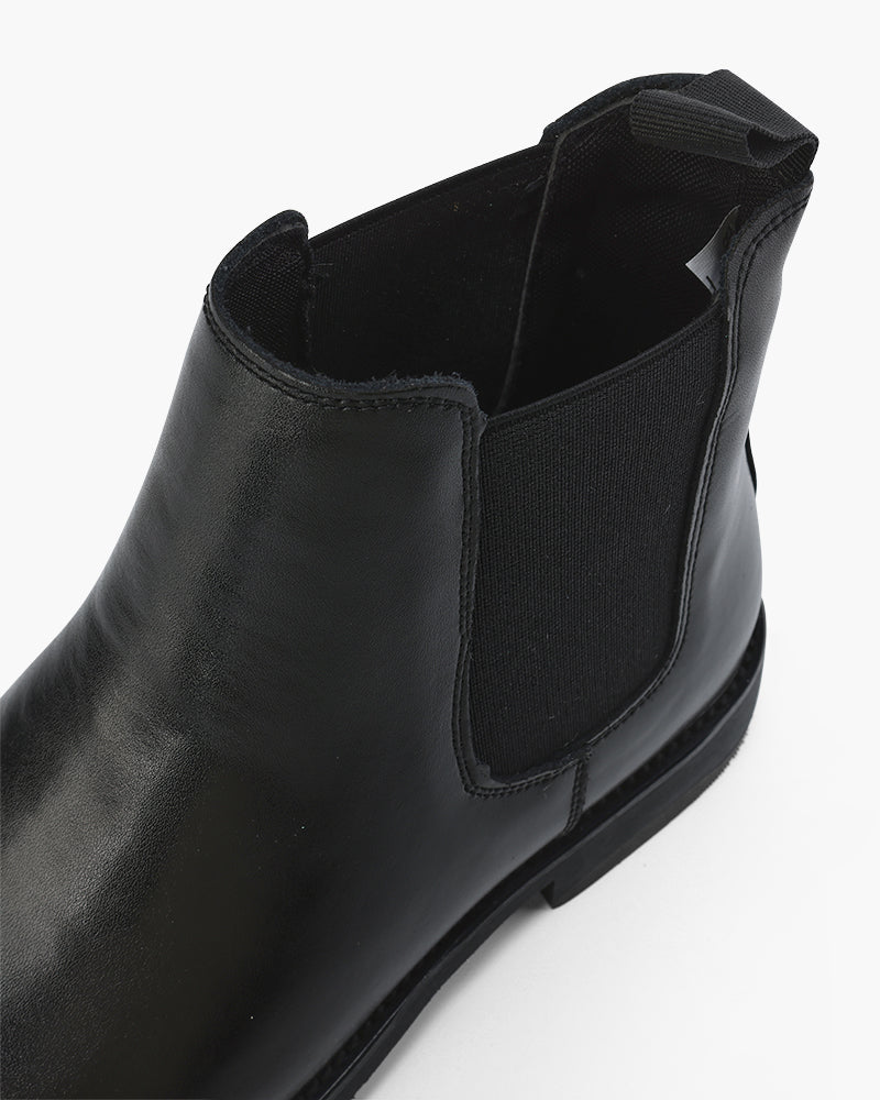Close-up of black Chelsea boot ankle opening and elastic gusset