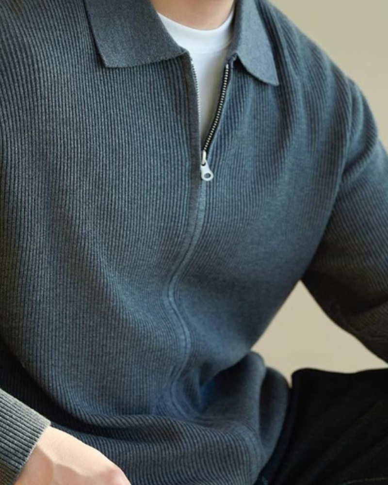 Close-up of a blue-grey ribbed full-zip wool jumper with collar and zip, on model with white tee