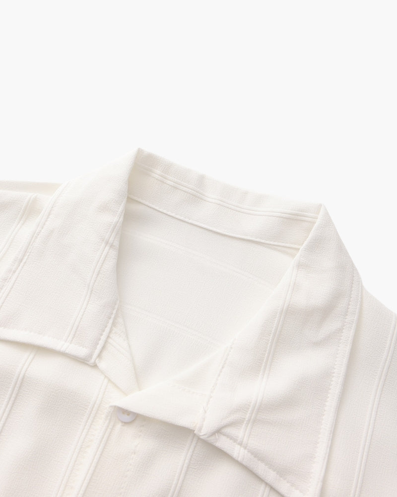 Close-up of white vertical-rib shirt open collar and rib texture