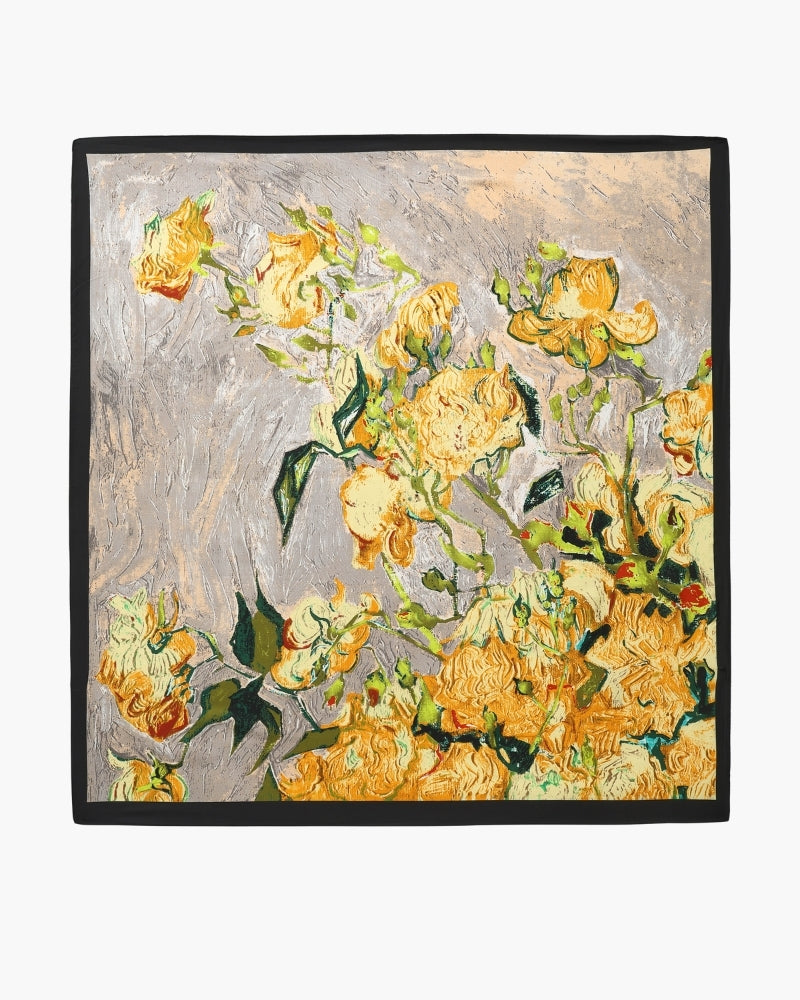 Yellow floral scarf with black border laid flat as a full square
