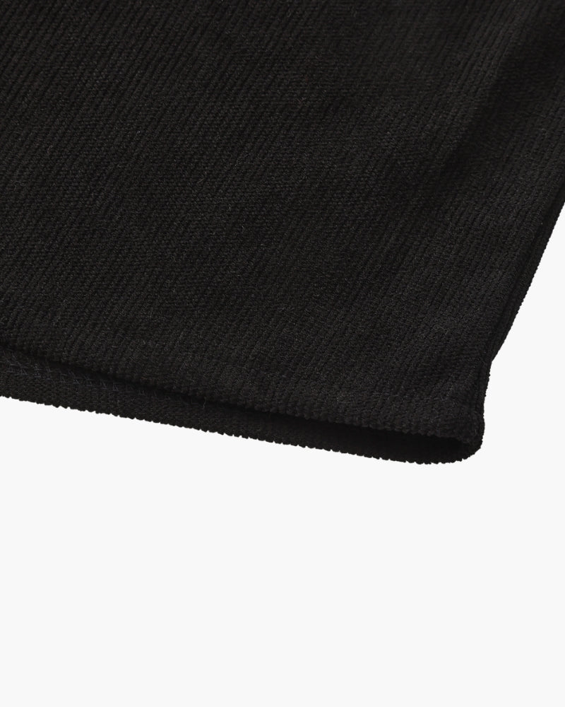 Close-up of black textured shirt sleeve hem with stitched edge, detail shot