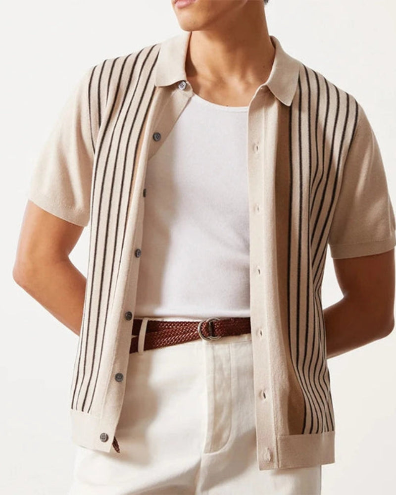 Close-up of a cream striped knit polo over a white tank top with a brown woven belt