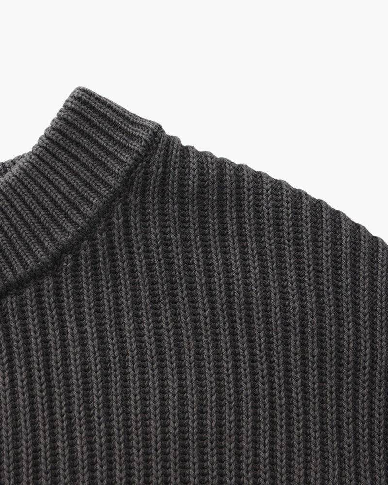 Close-up of charcoal-grey rib-knit jumper shoulder and ribbed neckline from the side
