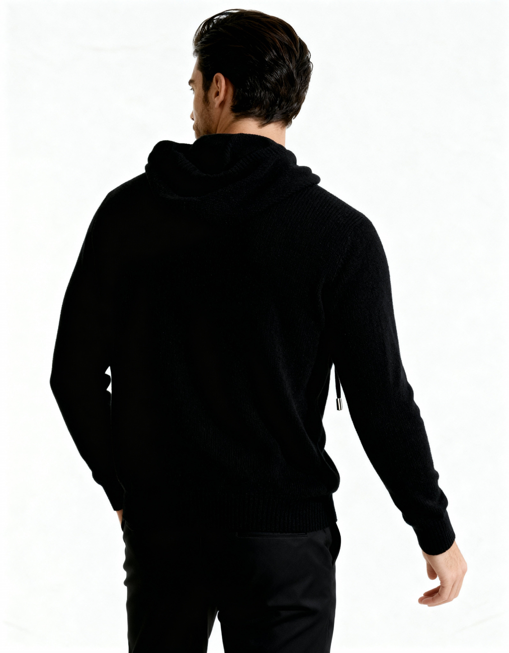 Back view of a black cashmere hoodie showing the hood and relaxed fit, on model