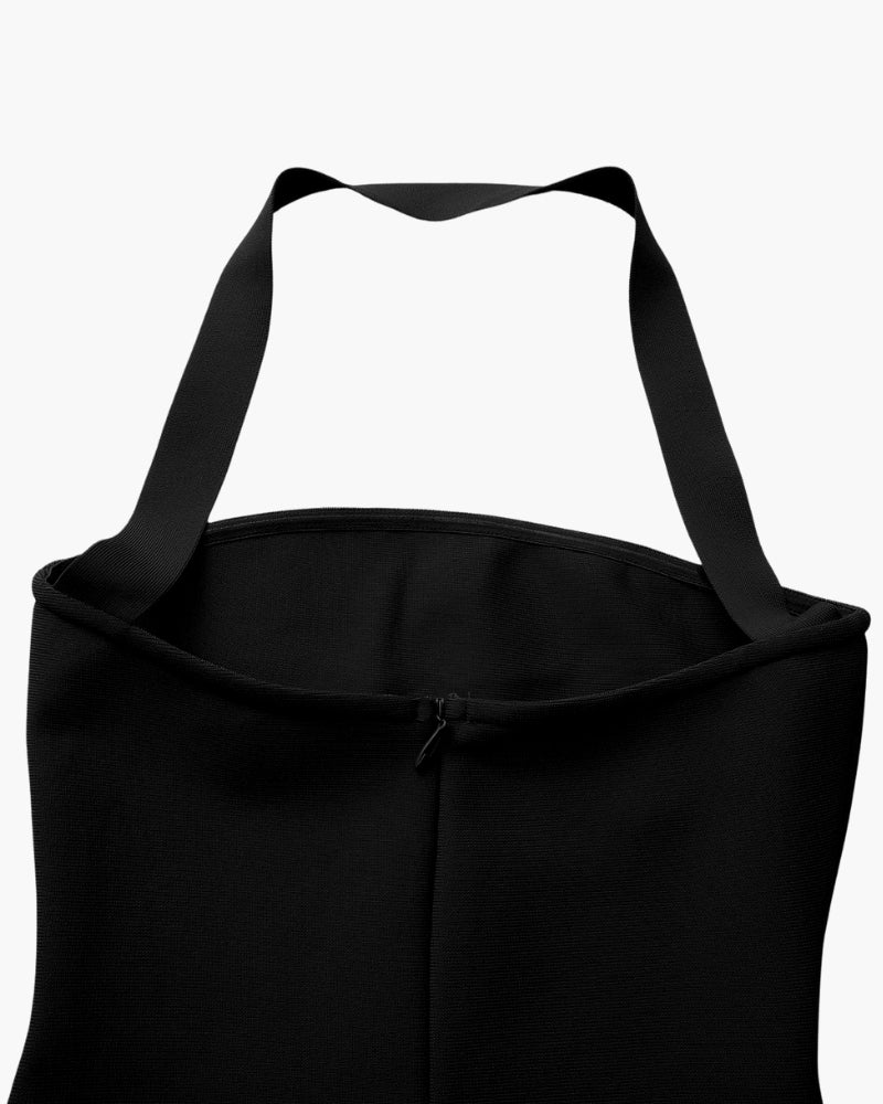 Primer plano de los tirantes halter y el escote de un vestido negro con cremallera trasera