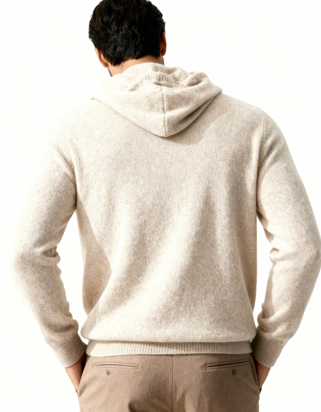 Back view of a beige cashmere hoodie showing the hood and relaxed shape, on model