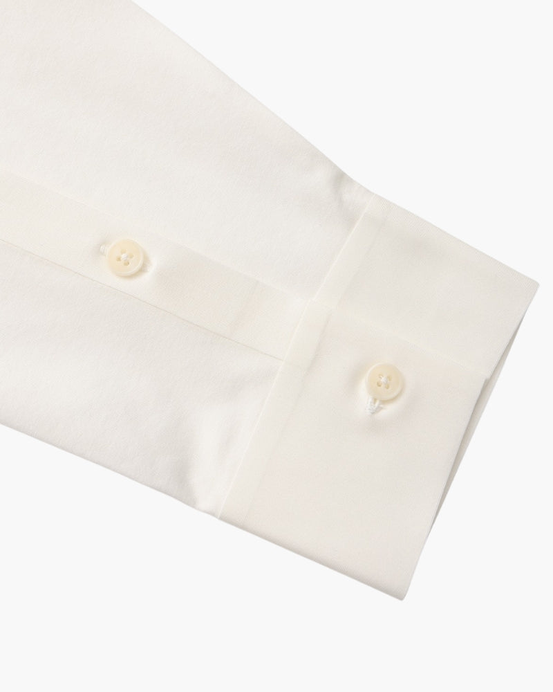 Close-up of white shirt cuff with two cream buttons, men's stretch cotton shirt