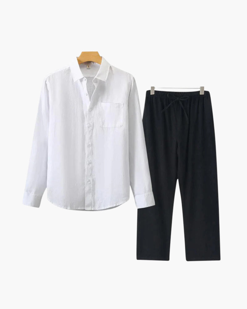 White linen shirt with chest pocket beside black drawstring trousers, flat-lay set on hangers