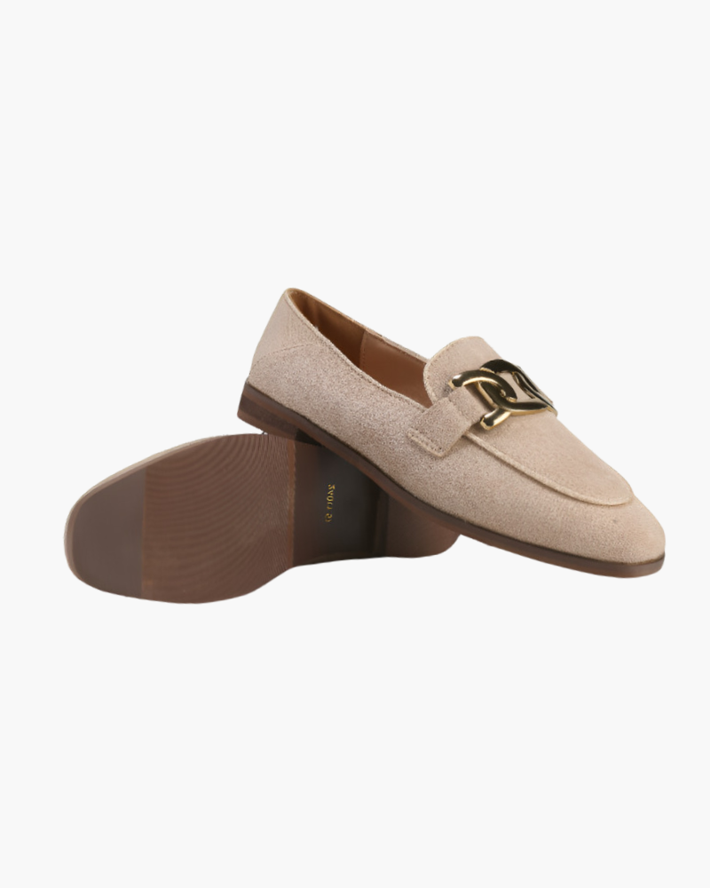 Beige suede loafer flat-lay on white showing gold chain vamp and brown leather sole
