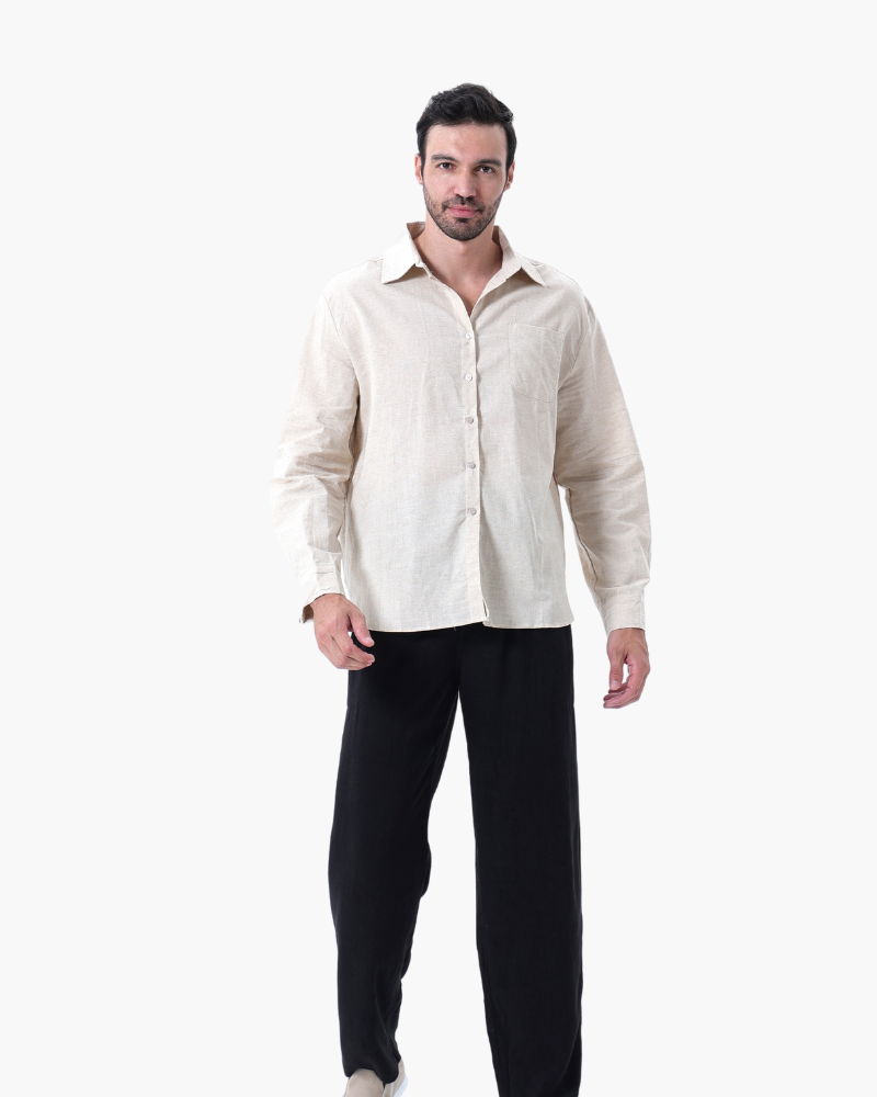 Man in a cream linen shirt with black trousers, front view on white