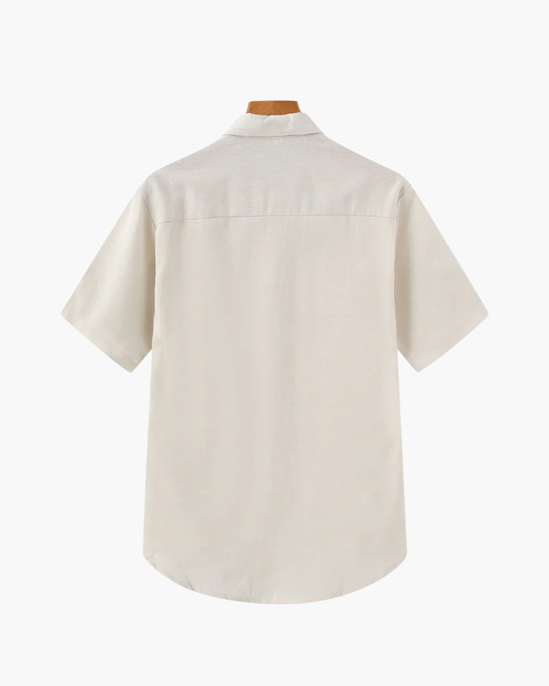 Back of a cream short-sleeve linen polo shirt with yoke seam, on a hanger