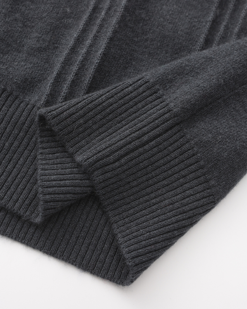 Close-up of a charcoal cashmere ribbed cuff and hem with knitted panel detail