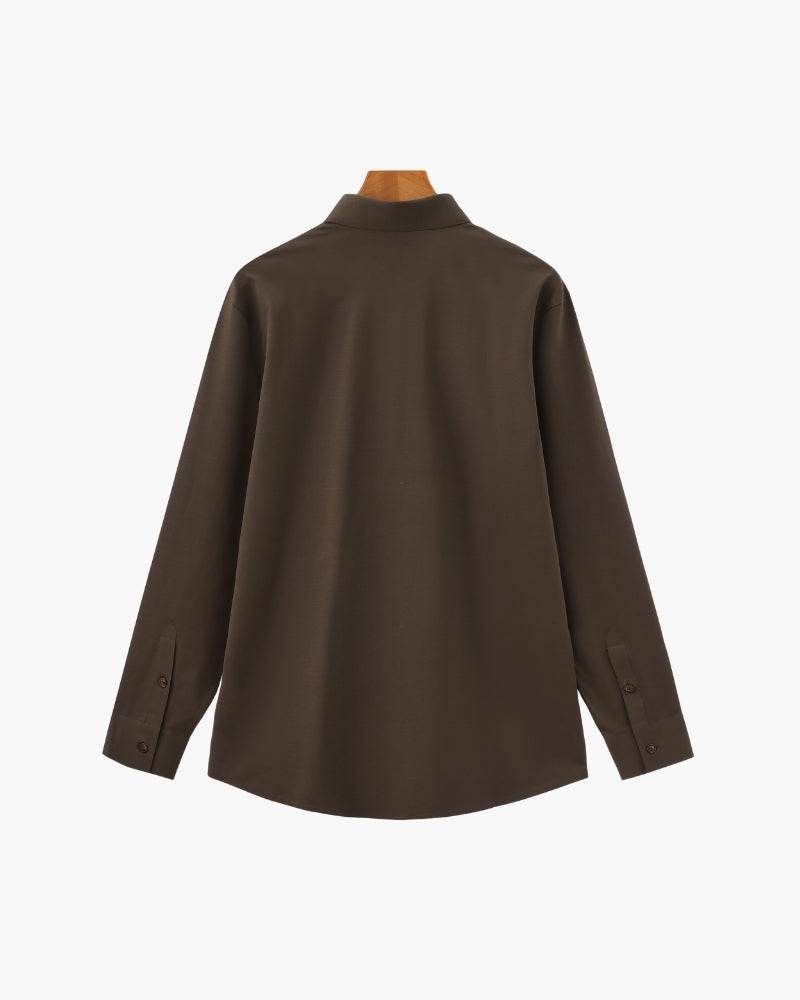 Dark brown long-sleeve shirt on a wooden hanger, flat back view with curved hem