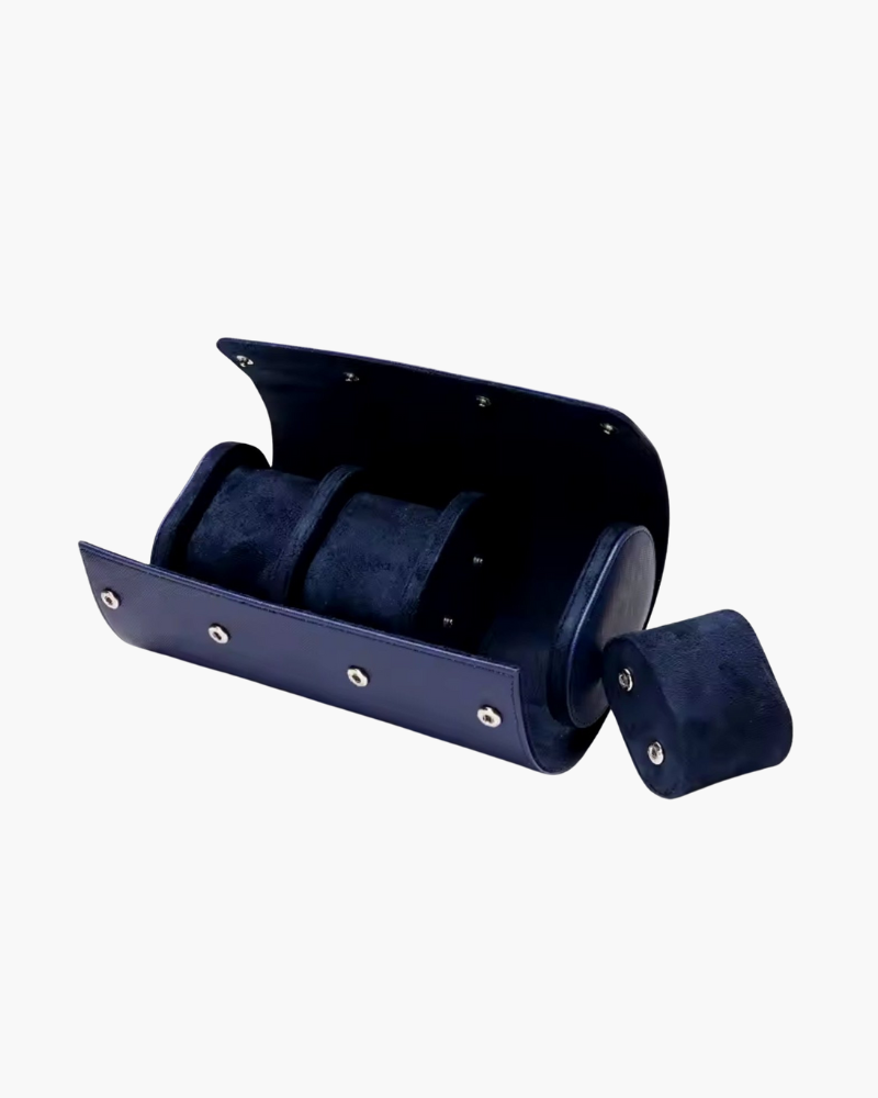 Navy leather three-watch roll case open with a spare cushion beside it