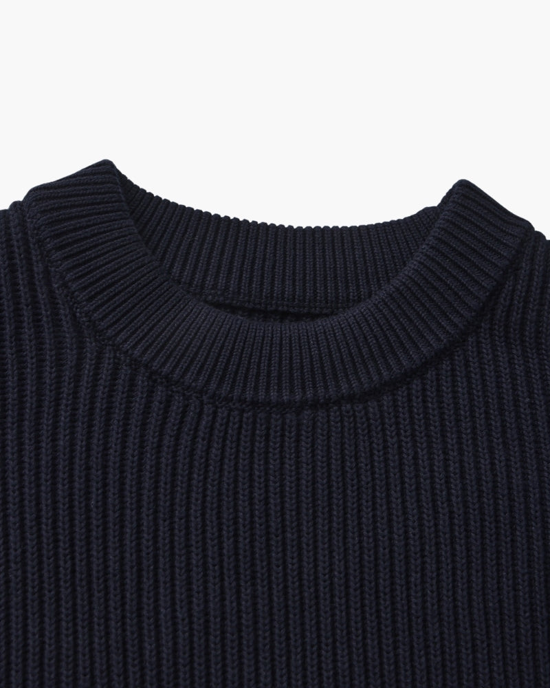 Close-up of navy rib-knit jumper ribbed crew neckline, flat-lay on white