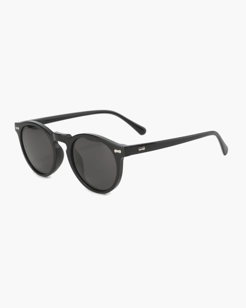 Black round acetate sunglasses with dark grey lenses and silver rivets, three-quarter view